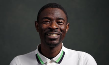 Souleymane Ouedraogo, in a polo shirt buttoned at the neck, grinning