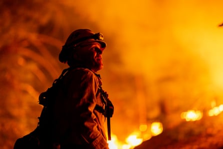 Los Angeles county firefighters use only hand tools to keep fire from jumping a fire break in Angeles National Forest on 11 September.