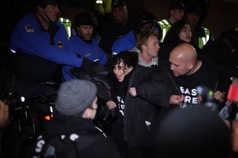 Members of U.S. Capitol Police pull protesters away from the headquarters of Democratic National Committee during a demonstration against the war between Israel and Hamas on November 15, 2023 on Capitol Hill in Washington, DC. Jewish Voice for Peace and If Not Now held a candlelight vigil to call for a ceasefire in the Israel-Hamas war.