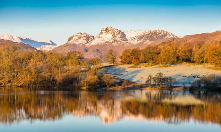 Mountains reflected in Loughrigg Tarn, Cumbria, UK.