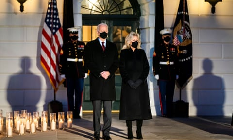 US president Joe Biden and his wife Jill observe a moment of silence for the 500,000 American victims of Covid-19 outside the White House