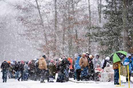 People wait to enter a Donald Trump campaign event during a winter snowstorm in Atkinson.