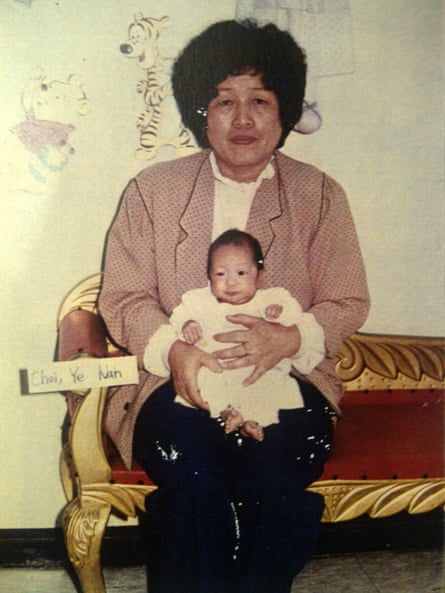 A woman holds a baby on her lap