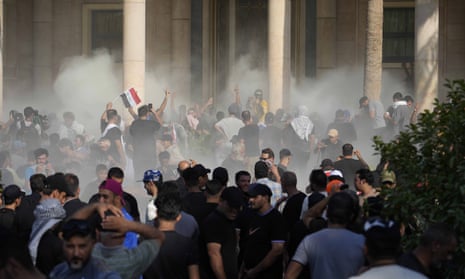 Iraqi security forces fire teargas during protests by supporters of the Shia cleric Muqtada al-Sadr inside the government palace in Baghdad