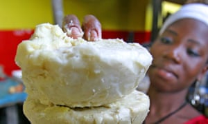 A woman sells shea butter in a market in Abidjan, Ivory Coast