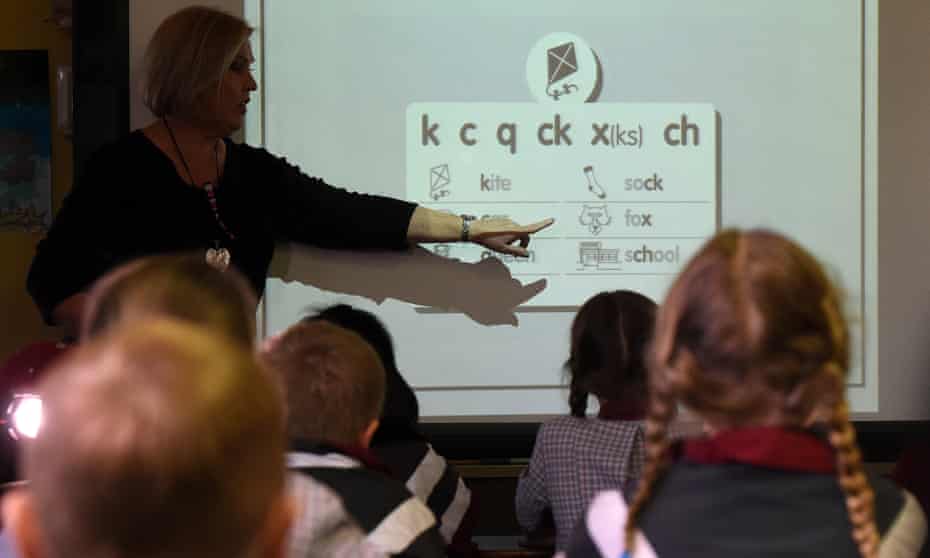 A teacher points at a board during a lesson in Brisbane