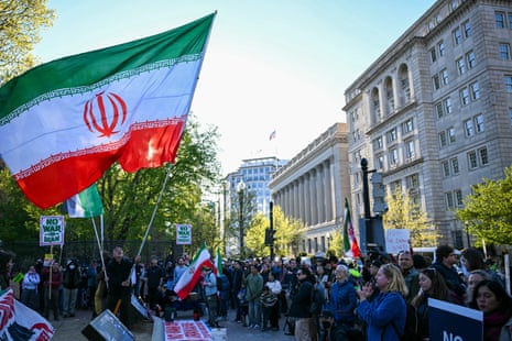 A protester waves an Iranian flag during a demonstration against US military action in Iran near the White House in Washington, DC, on April 7, 2026.