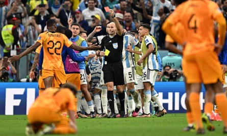 Antonio Mateu Lahoz shows a red card to the Netherlands defender Denzel Dumfries after Argentina had won the match on penalties.