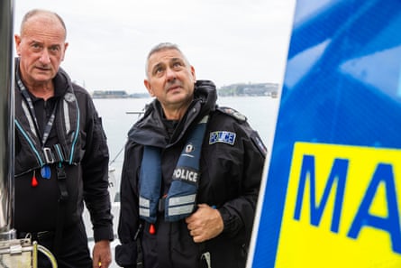 Two men in lifejackets on a boat
