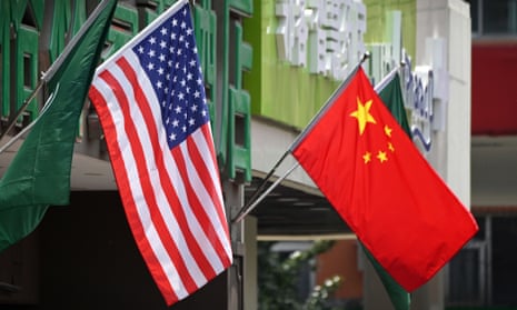 US and Chinese flags  displayed outside a hotel in Beijing