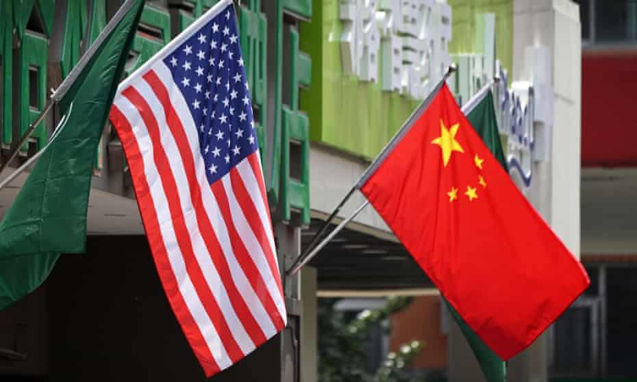 US and Chinese flags  displayed outside a hotel in Beijing