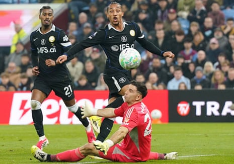 Chelsea’s Joao Pedro (right) dinks the ball over Aston Villa keeper Emiliano Martinez for his second goal of the game.