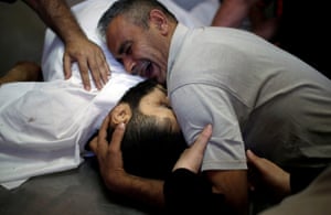 The family of Palestinian Shaher al-Madhoon, killed during a protest at the Israel-Gaza border, mourn at a hospital morgue in Gaza