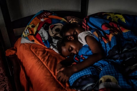 Cherokeena Robinson, 32 – who lost her job during the pandemic – lays in bed with her son Mai’Kel Stephens, 6, at their transitional house in San Pedro, California that they share with one or two other families at a time.