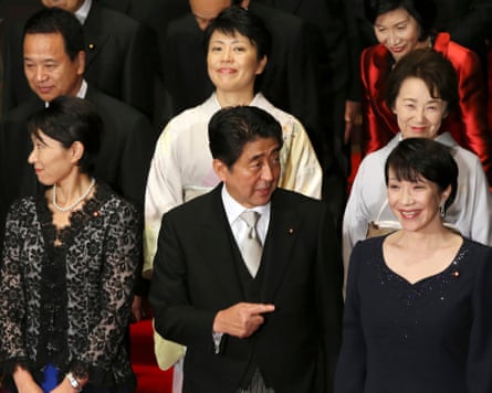 Japan’s prime minister Shinzo Abe, center, poses for a photo with his new Cabinet in 2014
