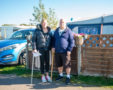 Mark Smith and his wife, Petra, stand next to eacher in a caravan park