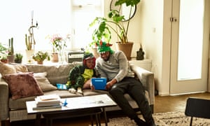 Psychological well being within the office: what can employers do to assist throughout Covid? | Getting again on monitor 3 Father and son in dragon costumes using tablet on sofa