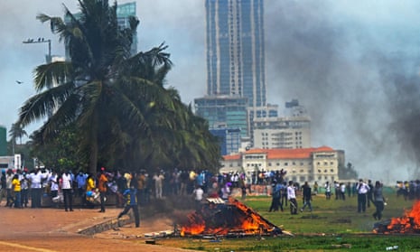 Demonstrators and government supporters clash outside the president's office in Colombo