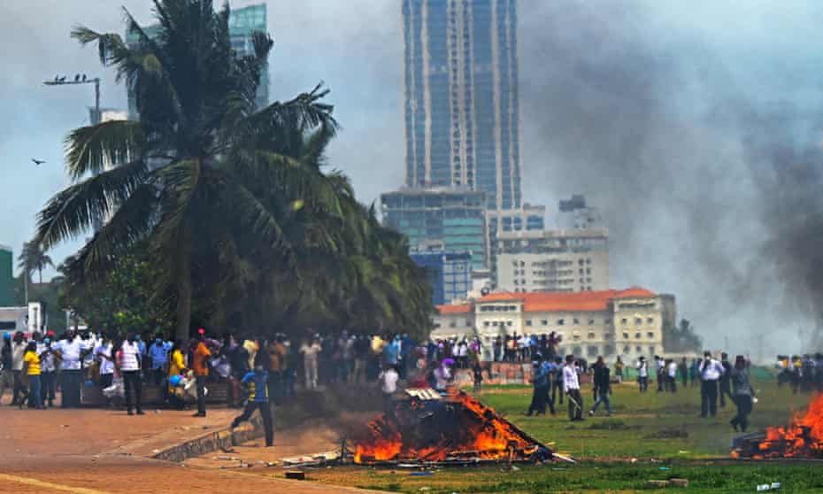 Demonstrators and government supporters clash outside the president's office in Colombo