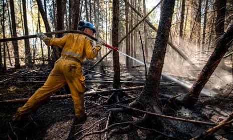 A Canadian Forces member from 41 Canadian Brigade Group (CBG) extinguishes a hotspot while fighting wildfires in Drayton Valley, Alberta, on Monday.