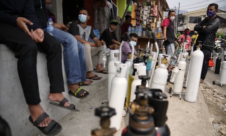 People queue to refill their oxygen cylinders in Jakarta