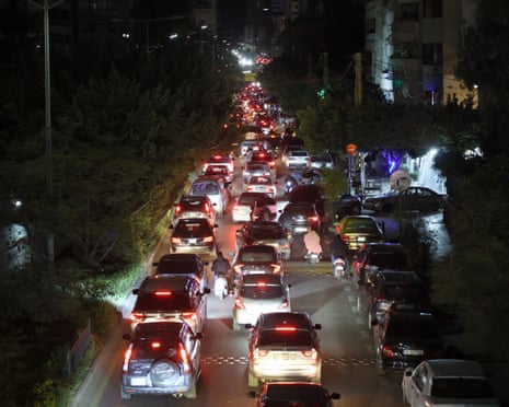 Lebanese people flee from the southern suburbs of Beirut after leaving their homes after Israeli strikes.