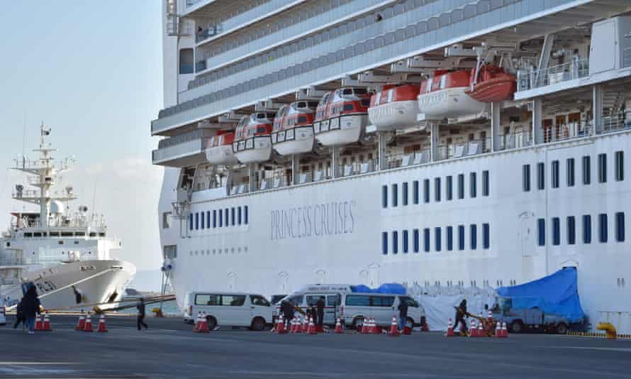Ambulances wait for patients who tested positive for the new coronavirus onboard the Diamond Princess cruise ship in Yokohama, Japan, on Thursday.