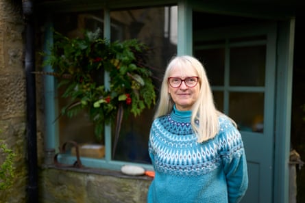 Nickolls outside a house with a Christmas wreath hanging on the window