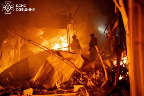 Firefighters tackling a blaze during the night.