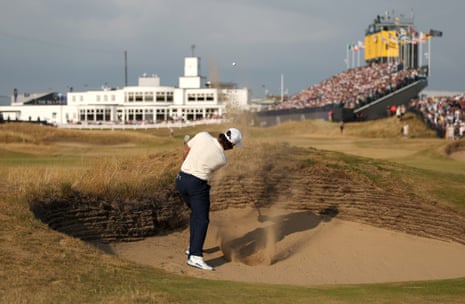 Tommy Fleetwood plays a shot from a bunker on the 18th.