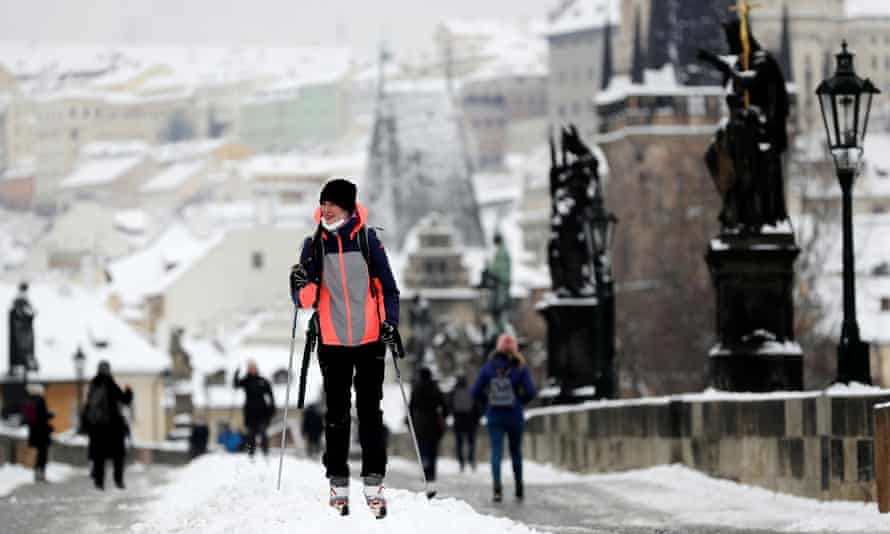 A woman cross-country skis across the medieval Charles Bridge in Prague, Czech Republic
