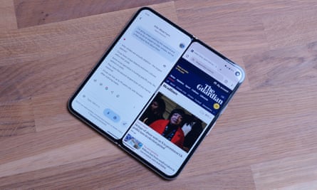 The Google Pixel 9 Pro Fold with the Gemini app open next to the Chrome app displaying the Guardian website.