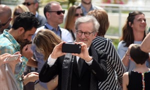 Steven Spielberg takes photos with his iPhone at this year’s Cannes film festival. 