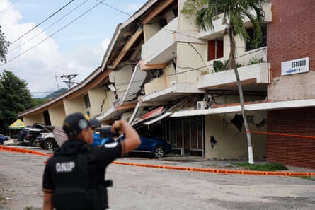 A person looks at buildings damaged by the 7.7-magnitude earthquake in Panama City