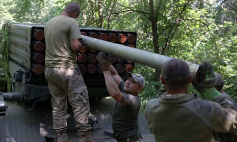 Ukrainian artillerymen load missiles onto a self-propelled multiple rocket launcher near Bakhmut, in eastern Ukraine’s Donetsk region