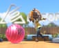An animated character mid-swing releases a pink bowling ball down a lane in Switch Sports Resort