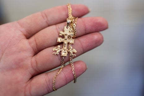 A woman holding a gold chain