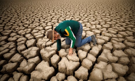 A hydrologist checks cracks in the dried up municipal dam in the drought-stricken town of Graaff-Reinet, South Africa, in November 2019. 