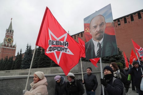 Communist supporters carry flags and a portrait of Russian revolutionary Vladimir Ilyich Ulyanov, better known as Lenin.