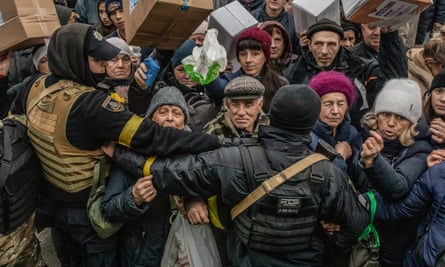 Kherson residents crowd round an aid truck distributing food parcels