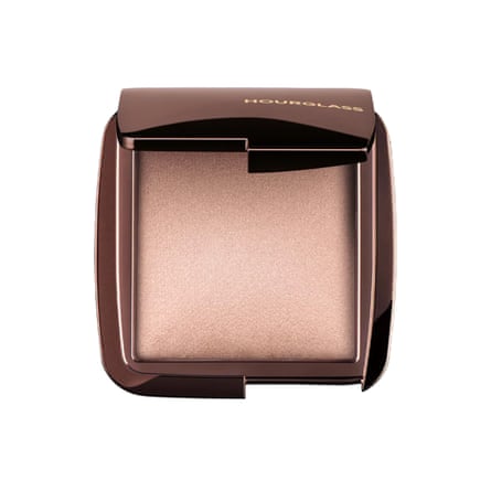 A compact of Hourglass’ Ambient Lighting Finishing Powder in Luminous Light. The lid is open revealing the product.