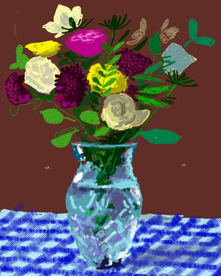 A vase of roses resting on a blue tablecloth