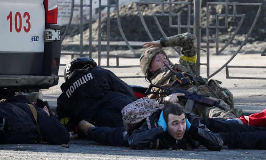 People take cover as an air-raid siren sounds in Kyiv on Saturday