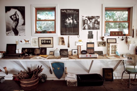 Pictures and posters on Mann’s wall. The portrait of her three children is from her Immediate Family series.