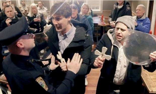 Jason Selvig and Davram Stiefler, AKA the Good Liars, are held back by police as they attempt to ‘exorcise’ Senator Ted Cruz.