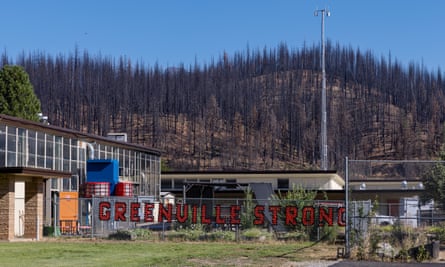 Burned trees can be seen on the hill behind Greenville elementary school in California.