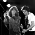 Stipe and Buck on stage in the 1980s.