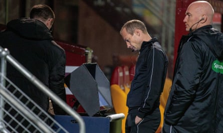 The referee Willie Collum checks the VAR screen during Celtic’s match at Motherwell