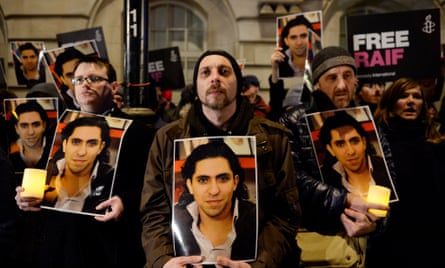Protesters take part in an Amnesty International protest in front of the Saudi embassy in London against the flogging of Raif Badawi.