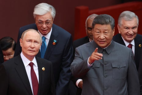 Vladimir Putin speaks with Xi Jinping after a group photograph during a visit in September 2025.